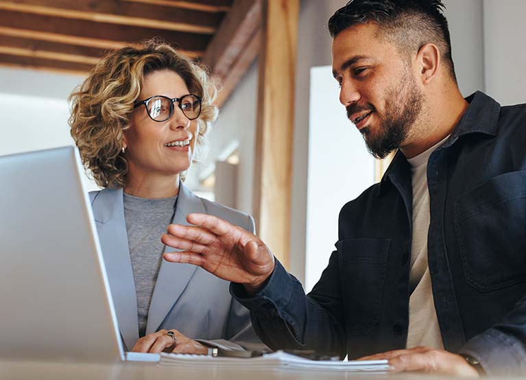 Business man having a discussion with his colleague in an office