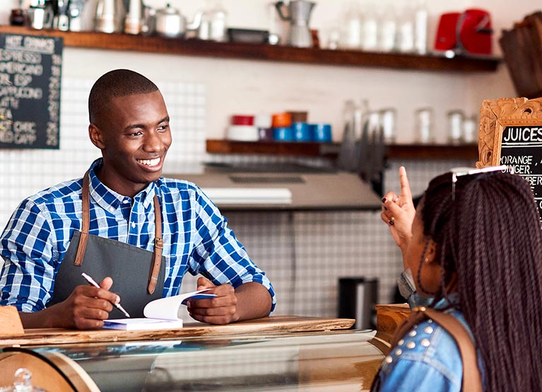 worker taking an order at a coffee shop