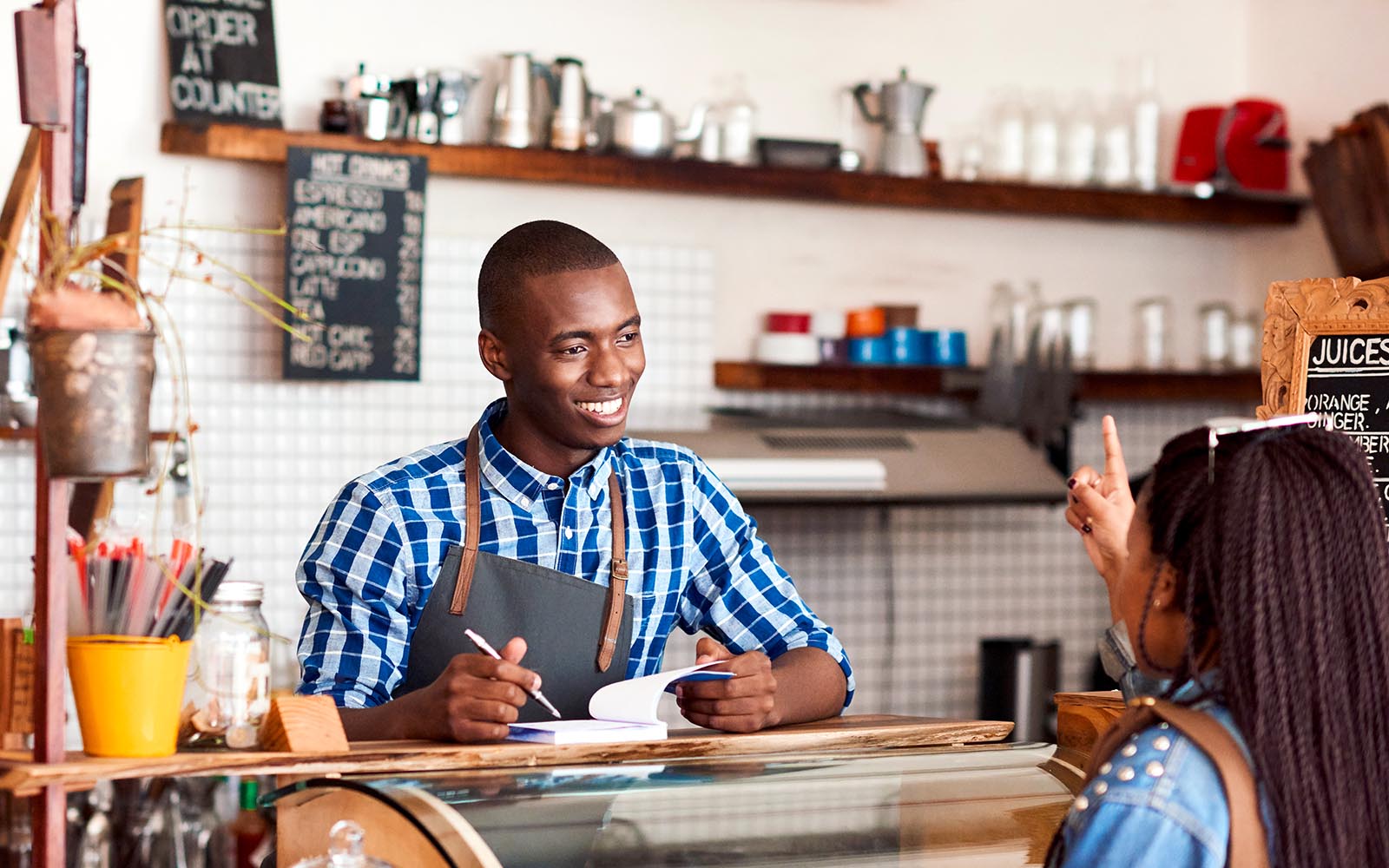 worker taking an order at a coffee shop