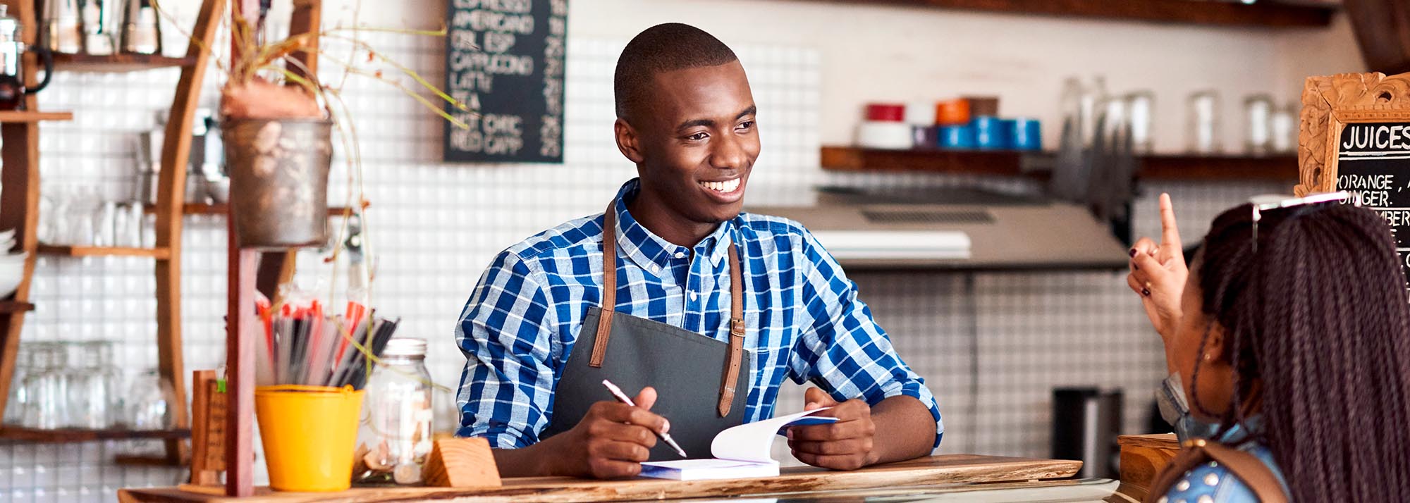 worker taking an order at a coffee shop